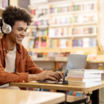 man sitting reading in library