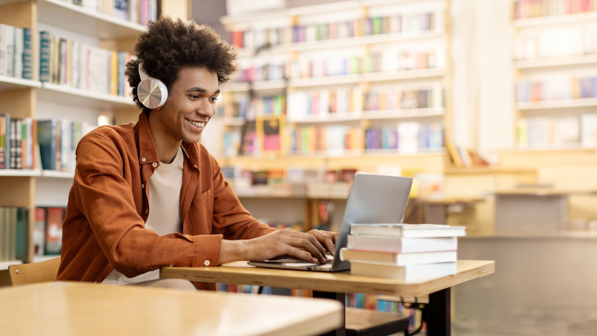 man sitting reading in library